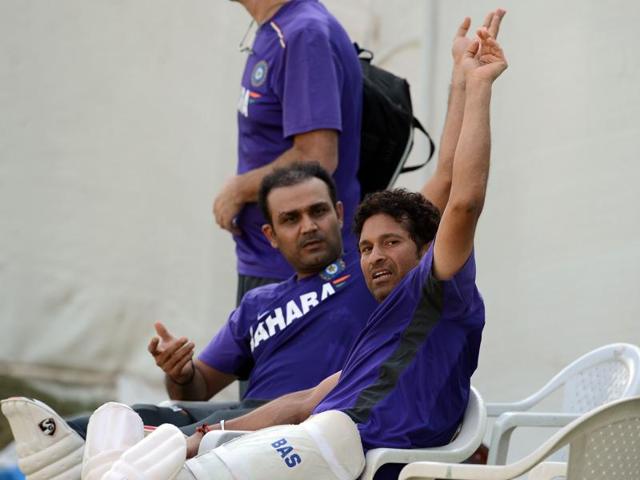 Sachin Tendulkar (R) and Sehwag gesture during a training session during the India-England home series in November 2012. (AFP) 
