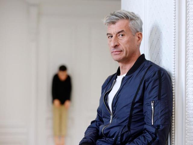 Cattelan poses with one of his creations. (AFP)