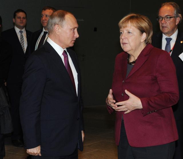 Russian President Vladimir Putin listens to German Chancellor Angela Merkel after their talks at a summit with the leaders of Russia, Germany and France about the situations in Syria at the chancellery in Berlin, Germany. (AP Photo) Russian President Vladimir Putin listens to German Chancellor Angela Merkel after their talks at a summit with the leaders of Russia, Germany and France about the situations in Syria at the chancellery in Berlin, Germany. (AP Photo)