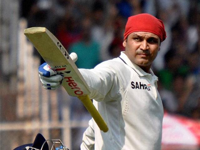 Sehwag celebrates his century on the opening day of the first Test against England at Motera in Ahmedabad on November 15, 2012. (PTI) 