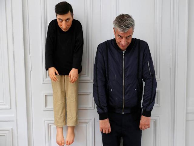 Cattelan poses with his creation La Rivoluzione Siamo Noi (2000) on October 17, 2016. (REUTERS)