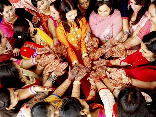 Teachers show their henna-applied hands during the Karva Chauth celebrations at a school in Reetkheri in Patiala. (PTI) Teachers show their henna-applied hands during the Karva Chauth celebrations at a school in Reetkheri in Patiala. (PTI)