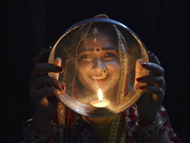 A women on the occasion of Karva Chauth in Mirzapur. (PTI) A women on the occasion of Karva Chauth in Mirzapur. (PTI)