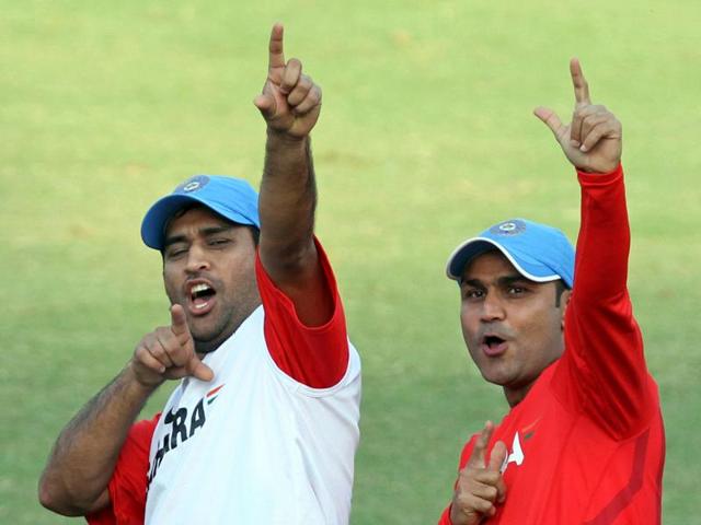 Sehwag and Dhoni share a lighter moment at a practice session during the 2011 World Cup in India. (Mohd. Zakir/HT Photo) 