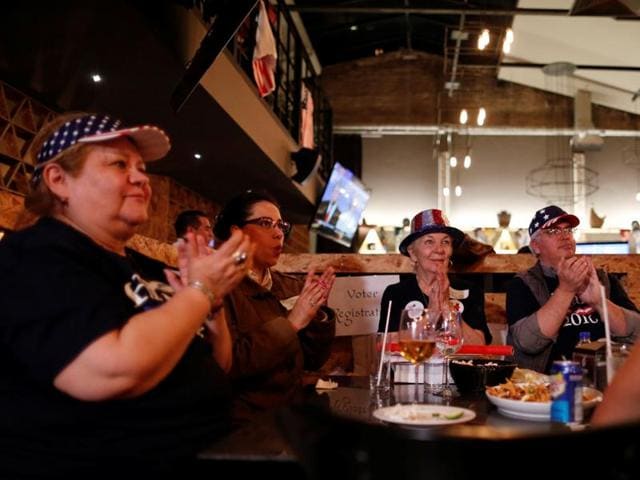 Democrats react as they watch a television broadcast of the third presidential debate at a restaurant in Mexico City, Mexico. (Reuters Photo) Democrats react as they watch a television broadcast of the third presidential debate at a restaurant in Mexico City, Mexico. (Reuters Photo)