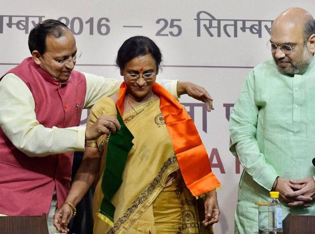 BJP president Amit Shah looks on as party leader Arun Singh presents a scarf to former UP Congress chief Rita Bahuguna Joshi, who joined the BJP in New Delhi on Thursday. (PTI) BJP president Amit Shah looks on as party leader Arun Singh presents a scarf to former UP Congress chief Rita Bahuguna Joshi, who joined the BJP in New Delhi on Thursday. (PTI)