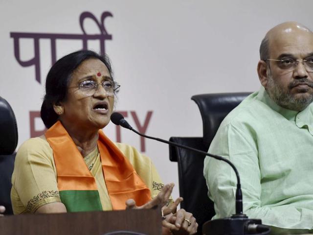 BJP president Amit Shah looks on as former UP Congress president Rita Bahuguna Joshi speaks to media after joining the Bharatiya Janata Party at party headquarters in New Delhi. (PTI Photo) BJP president Amit Shah looks on as former UP Congress president Rita Bahuguna Joshi speaks to media after joining the Bharatiya Janata Party at party headquarters in New Delhi. (PTI Photo)