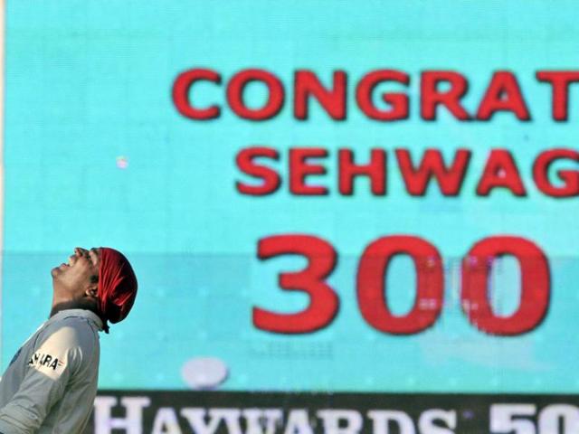 Sehwag looks up to the heavens in celebration as a TV screen flashes congratulations for scoring a triple ton, his second, on the third day of the first Test against South Africa in Chennai on March 28, 2008. (AP) 