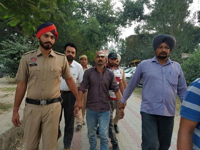 The accused in police custody on Wednesday. (HT Photo) The accused in police custody on Wednesday. (HT Photo)