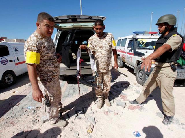 A fighter of Libyan forces allied with the UN-backed government holds an explosive belt left behind by Islamic State militants near the eastern frontline in Sirte, Libya, on Thursday. (Reuters) A fighter of Libyan forces allied with the UN-backed government holds an explosive belt left behind by Islamic State militants near the eastern frontline in Sirte, Libya, on Thursday. (Reuters)