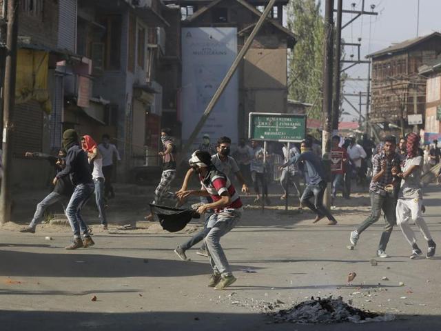Kashmiri protesters throw stones on police vehicles during a protest in Srinagar, Kashmir. (AP File Photo) Kashmiri protesters throw stones on police vehicles during a protest in Srinagar, Kashmir. (AP File Photo)