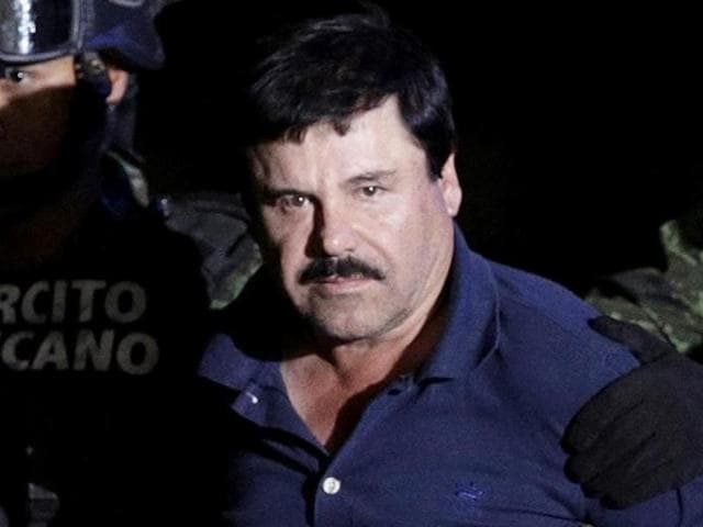Recaptured drug lord Joaquin "El Chapo" Guzman is escorted by soldiers at the hangar belonging to the office of the Attorney General in Mexico City, Mexico January 8, 2016. (Reuters File Photo)