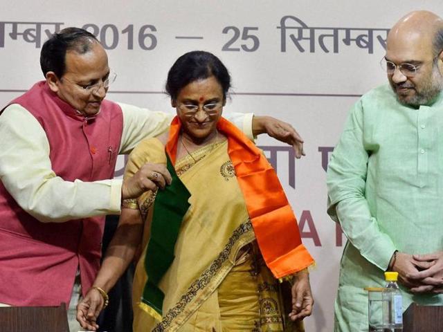 BJP President Amit Shah looks on as party leader Arun Singh presents a party scarf to former UP Congress president Rita Bahuguna Joshi at party headquarters in New Delhi on Thursday. (PTI) BJP President Amit Shah looks on as party leader Arun Singh presents a party scarf to former UP Congress president Rita Bahuguna Joshi at party headquarters in New Delhi on Thursday. (PTI)