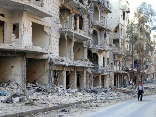 A man walks past damaged buildings in the rebel held besieged al-Sukkari neighbourhood of Aleppo, Syria. (Reuters Photo) A man walks past damaged buildings in the rebel held besieged al-Sukkari neighbourhood of Aleppo, Syria. (Reuters Photo)