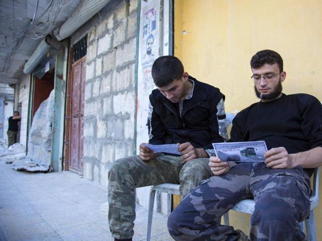 Opposition fighters from the Sham Legion look at flyers reportedly distributed by the government encouraging people to leave a rebel-held area in the northern embattled city of Aleppo on Thursday. A "humanitarian pause" in the Syrian army's Russian-backed assault on Aleppo took effect but despite a drop in violence there was little sign residents were heeding calls to leave. (AFP) Opposition fighters from the Sham Legion look at flyers reportedly distributed by the government encouraging people to leave a rebel-held area in the northern embattled city of Aleppo on Thursday. A "humanitarian pause" in the Syrian army's Russian-backed assault on Aleppo took effect but despite a drop in violence there was little sign residents were heeding calls to leave. (AFP)