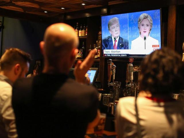 People watch the third US presidential debate between Hillary Clinton and Donald Trump at Murphy's Tap House in uptown Charlotte, North Carolina. (AFP Photo) People watch the third US presidential debate between Hillary Clinton and Donald Trump at Murphy's Tap House in uptown Charlotte, North Carolina. (AFP Photo)