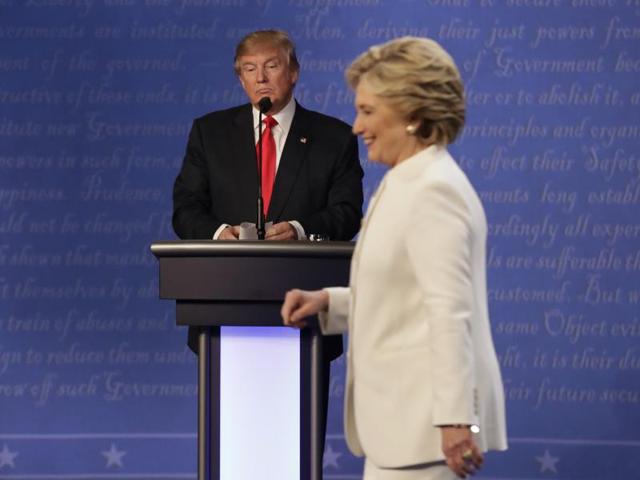 Republican presidential nominee Donald Trump waits behind his podium as Democratic presidential nominee Hillary Clinton makes her way off the stage following the third presidential debate in Las Vegas on October 19, 2016. (AP)
