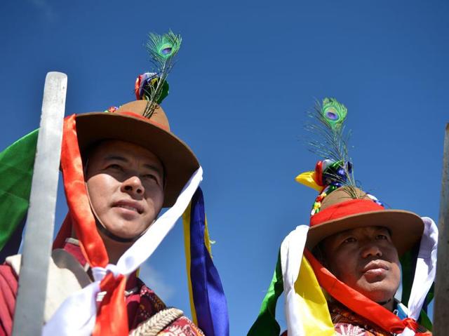 It is surrounded by beautiful glacial lakes with crystal-clear waters. Men in traditional dress look on during the opening ceremony. (AFP)