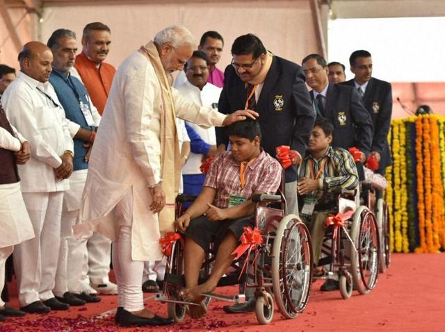 Prime Minister Narendra Modi distributes aid and equipment at the Saamaajik Adhikaarita Shivir in Vadodara. (PTI) Prime Minister Narendra Modi distributes aid and equipment at the Saamaajik Adhikaarita Shivir in Vadodara. (PTI)