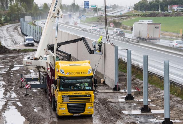 Workers operate a crane to set up concrete blocks in Calais, northern France, to build a 4-metre-high wall, dubbed the 'Great Wall of Calais', aimed at preventing migrants and refugees from attempting to reach Britain. French Interior Minister Bernard Cazeneuve said on October 18, 2016 the demolition of the "Jungle" migrant camp in Calais would take place "within days" after a court rejected a last-ditch bid by charities to block it. (AFP) Workers operate a crane to set up concrete blocks in Calais, northern France, to build a 4-metre-high wall, dubbed the 'Great Wall of Calais', aimed at preventing migrants and refugees from attempting to reach Britain. French Interior Minister Bernard Cazeneuve said on October 18, 2016 the demolition of the "Jungle" migrant camp in Calais would take place "within days" after a court rejected a last-ditch bid by charities to block it. (AFP)