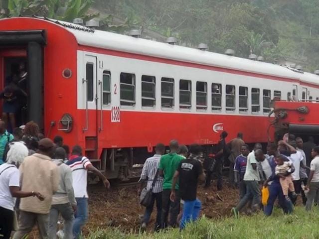 In this image made from video, people walk beside a derailed train carriage after an accident in Eseka, Cameroon.(AP) In this image made from video, people walk beside a derailed train carriage after an accident in Eseka, Cameroon.(AP)