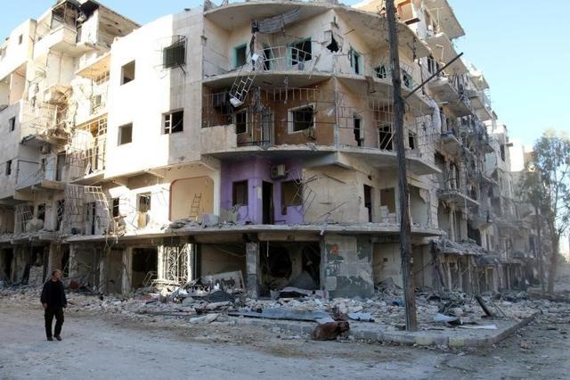 A man walks past damaged buildings in the rebel held besieged al-Sukkari neighbourhood of Aleppo. (Reuters Photo) A man walks past damaged buildings in the rebel held besieged al-Sukkari neighbourhood of Aleppo. (Reuters Photo)