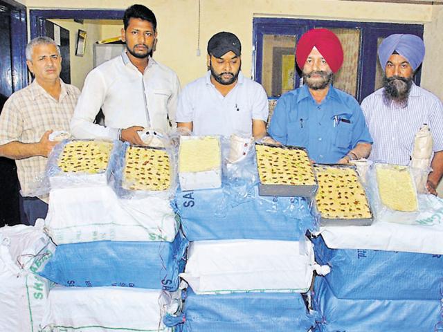 Health officials with the spurious sweets seized during a raid in Amritsar on Sunday.(HT Photo) Health officials with the spurious sweets seized during a raid in Amritsar on Sunday.(HT Photo)