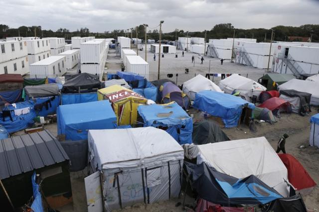 A view shows makeshift shelters, tents and containers where migrants live. (Reuters Photo) A view shows makeshift shelters, tents and containers where migrants live. (Reuters Photo)
