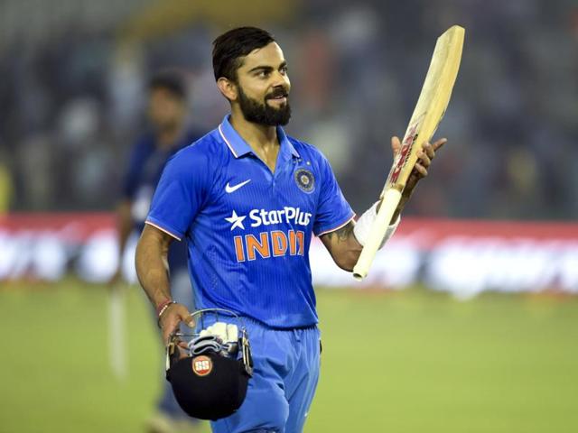 Kohli raises his bat in celebration after the match. He played an unbeaten knock of 154. (Keshav Singh/HT Photo)