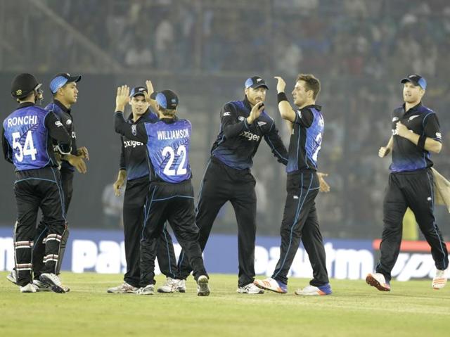 New Zealand's James Neesham, right, Matt Henry, second right, Martin Guptil, third right, and teammates celebrate the dismissal of India's MS Dhoni. (AP)