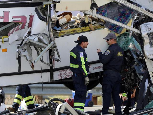 Investigators speak to each other at the scene of a mass casualty bus crash on the westbound Interstate 10 freeway near Palm Springs, California. (Reuters Photo)