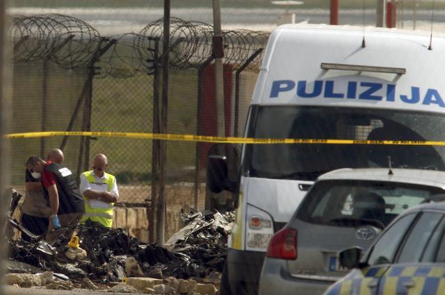 Investigators and rescue services at the scene of a plane crash at the airport in Valletta, Malta, on Monday. (Reuters)