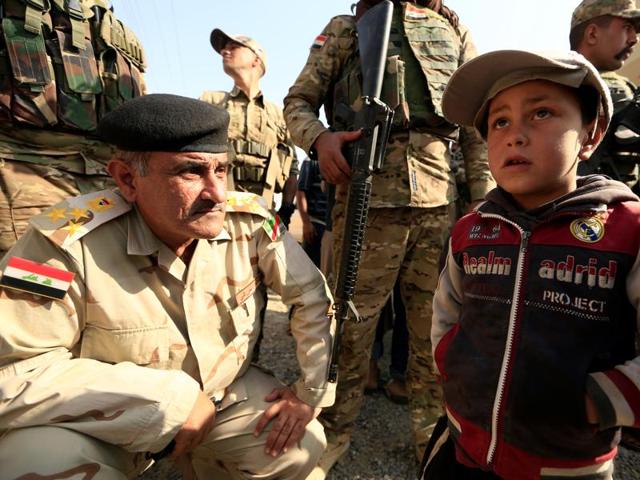 A boy whose village was taken by Iraqi army from Islamic State talks to soldiers beside his house at the town of Harrarah near Mosul, Iraq. (REUTERS) A boy whose village was taken by Iraqi army from Islamic State talks to soldiers beside his house at the town of Harrarah near Mosul, Iraq. (REUTERS)