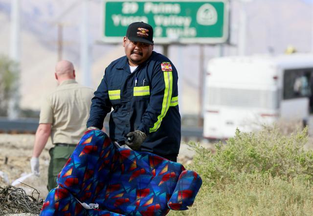 A tow truck driver helps clear debris at the scene. (REUTERS) A tow truck driver helps clear debris at the scene. (REUTERS)