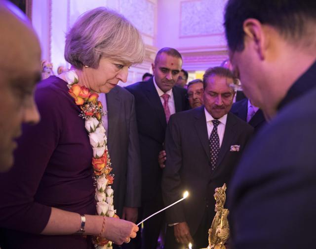 Prime Minister Theresa May lights a traditional lamp during Diwali celebrations at 10 Downing Street on Monday. (www.gov.uk)