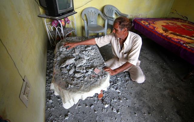 A man cleans his house which was damaged from alleged firing from Pakistan in RS Pura. (Nitin Kanotra/HT Photo) A man cleans his house which was damaged from alleged firing from Pakistan in RS Pura. (Nitin Kanotra/HT Photo)