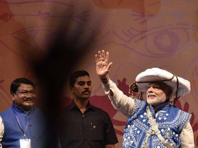 Modi waves to the gathering at the National Tribal Carnival. (Arun Sharma/HT PHOTO) Modi waves to the gathering at the National Tribal Carnival. (Arun Sharma/HT PHOTO)