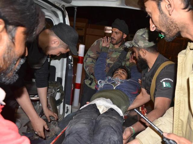 Pakistani volunteers and police officers rush an injured person to a hospital in Quetta, Pakistan, Monday, after two separate attacks in Pakistan. (AP) Pakistani volunteers and police officers rush an injured person to a hospital in Quetta, Pakistan, Monday, after two separate attacks in Pakistan. (AP)