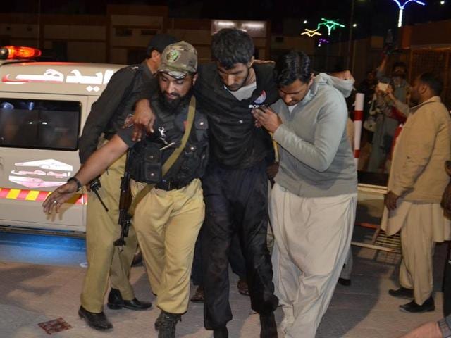 A Pakistani volunteer and a police officer rush an injured person to a hospital in Quetta (AP) A Pakistani volunteer and a police officer rush an injured person to a hospital in Quetta (AP)