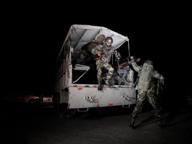 A police truck is seen at a gate to the Police Training Center after an attack on the center in Quetta, Pakistan. (Reuters Photo) A police truck is seen at a gate to the Police Training Center after an attack on the center in Quetta, Pakistan. (Reuters Photo)