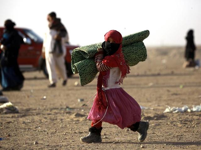 An Iraqi refugee girl who fled Mosul walks in the desert area of Rajam al-Saliba on the Iraq-Syria border south of al-Hol in Syria's Hassakeh province. (AFP) An Iraqi refugee girl who fled Mosul walks in the desert area of Rajam al-Saliba on the Iraq-Syria border south of al-Hol in Syria's Hassakeh province. (AFP)
