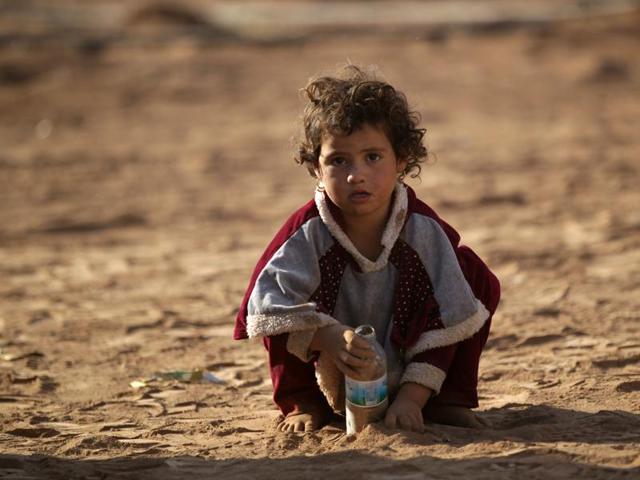 An Iraqi refugee girl that fled violence in Mosul plays with sand upon arrival in al-Kherbeh village, northern Aleppo province, Syria. (REUTERS) An Iraqi refugee girl that fled violence in Mosul plays with sand upon arrival in al-Kherbeh village, northern Aleppo province, Syria. (REUTERS)
