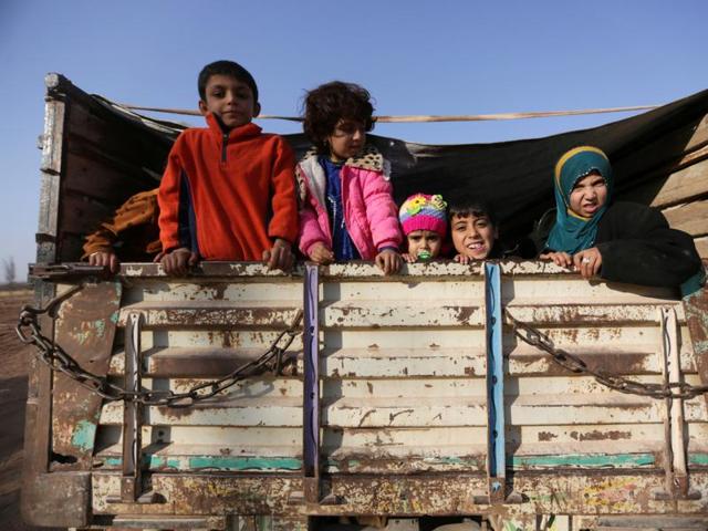 Iraqi refugees that fled violence in Mosul ride a pick-up truck upon arrival in al-Kherbeh village, northern Aleppo province, Syria. (REUTERS) Iraqi refugees that fled violence in Mosul ride a pick-up truck upon arrival in al-Kherbeh village, northern Aleppo province, Syria. (REUTERS)