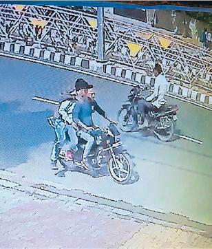 A CCTV grab showing the robbers fleeing after attacking the victims and snatching their bag containing Rs 24 lakh in Amritsar on Monday. (HT Photo)