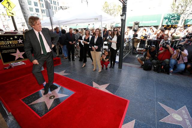 Hugh Laurie poses on his star. (REUTERS) Hugh Laurie poses on his star. (REUTERS)