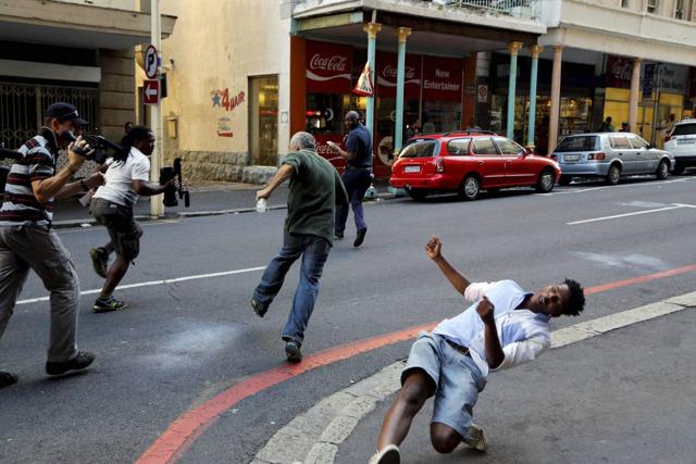 A student protestor, right, is hit by a rock thrown by a fellow protestor in Cape Town, South Africa, Wednesday, Oct. 26, 2016. (AP) A student protestor, right, is hit by a rock thrown by a fellow protestor in Cape Town, South Africa, Wednesday, Oct. 26, 2016. (AP)