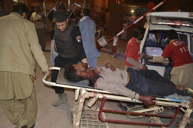 Pakistani volunteers rush an injured person to a hospital in Quetta on Monday night. (AP) Pakistani volunteers rush an injured person to a hospital in Quetta on Monday night. (AP)