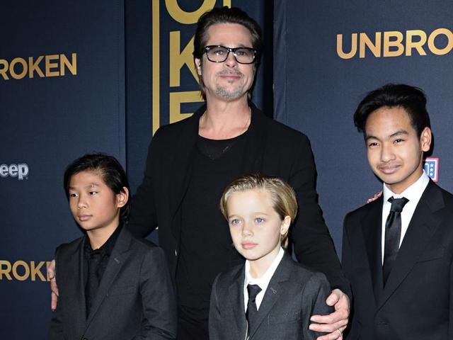 This file photo taken on December 15, 2014 shows actor Brad Pitt and children Pax Jolie-Pitt (L), Shiloh Jolie-Pitt (C) and Maddox Jolie-Pitt.(AFP)