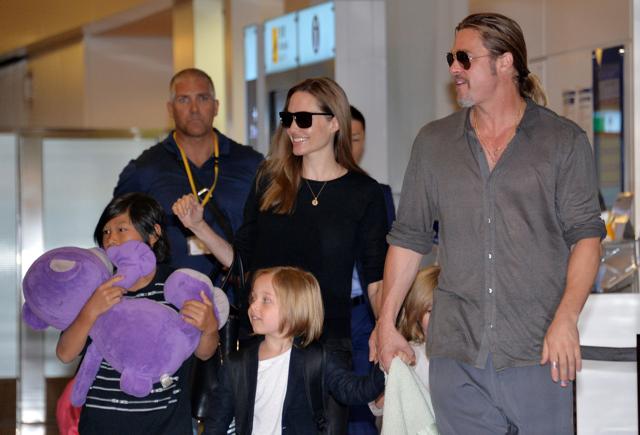 This file photo taken on July 28, 2013 shows US film stars Brad Pitt (R) and Angelina Jolie (C), accompanied by their children,as they arrive at Haneda International Airport in Tokyo. (AFP)
