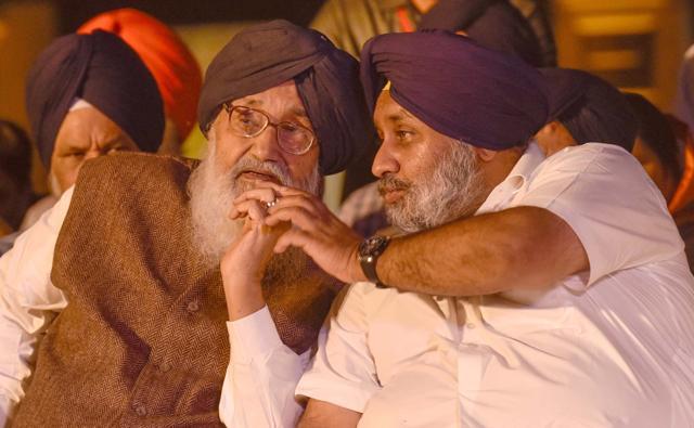 Deputy CM Sukhbir Singh Badal talks to his father, CM Parkash Singh Badal, at the inauguration function. (Gurpreet Singh/HT Photo)